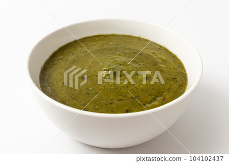Spinach curry on white background Spinach curry on white background 104102437