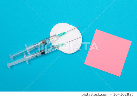 Vaccination or Revaccination Concept - Two Medical Syringe on Blue Table 104102985