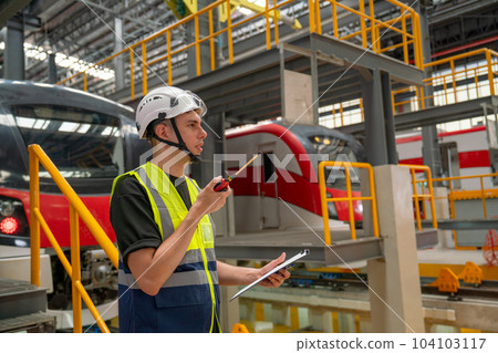 Technician or engineer worker man hold walkie talkie to contact with team member or staff Technician or engineer worker man hold walkie talkie to contact with team member or staff 104103117