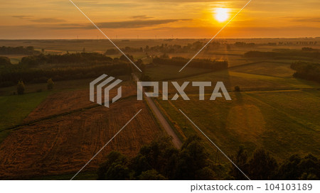 Colorful sunset over forest and fields Colorful sunset over forest and fields 104103189