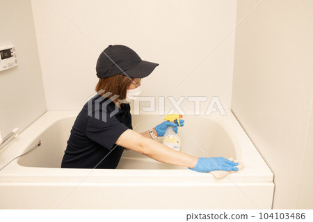 Female worker cleaning the bathroom Female worker cleaning the bathroom 104103486