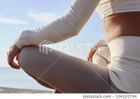 Young woman doing yoga in nature. Female wearing sport clothes in lotus figure. Young woman doing yoga in nature. Female wearing sport clothes in lotus figure. 104103744