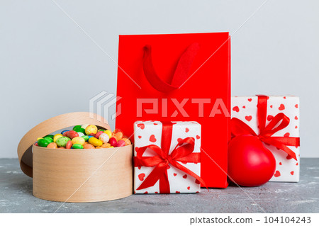 Shopping bag with gift box on colored background perspecrive view. Space for text holiday concept 104104243