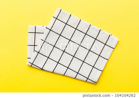 top view with white empty kitchen napkin isolated on table background. Folded cloth for mockup with copy space, Flat lay. Minimal style 104104262
