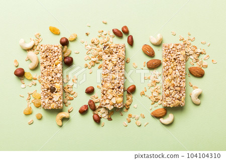 Various granola bars on table background. Cereal granola bars. Superfood breakfast bars with oats, nuts and berries, close up. Superfood concept Various granola bars on table background. Cereal granola bars. Superfood breakfast bars with oats, nuts and berries, close up. Superfood concept 104104310