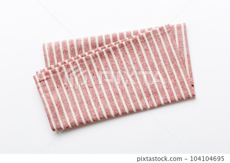 top view with red empty kitchen napkin isolated on table background. Folded cloth for mockup with copy space, Flat lay. Minimal style 104104695