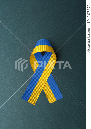 yellow and blue ribbon on green background 104107271