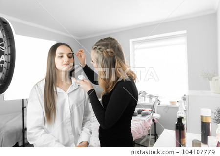 A moment has been recorded when the master of cosmetology carefully works on eyebrow correction. His technical skills and attentive approach guarantee impeccable results and customer satisfaction. 104107779