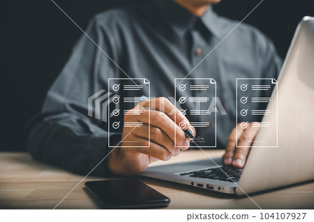 Paperless office concept with electronic signature. Businessman signs digital documents on virtual screen using pen. E-signing, technology, and document management. Agreement is established. Paperless office concept with electronic signature. Businessman signs digital documents on virtual screen using pen. E-signing, technology, and document management. Agreement is established. 104107927