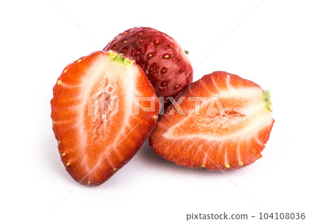 Isolated red strawberries. Three fruits, one cut in half on a white background 104108036