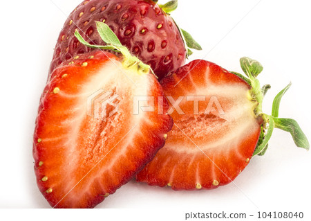 Isolated red strawberries. Three fruits, one cut in half on a white background 104108040