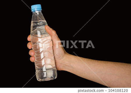 bottle with water in hand isolated on black background 104108120