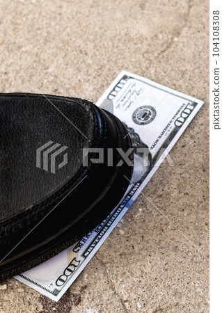 One hundred dollar bill under the shoe One hundred dollar bill under the shoe 104108308