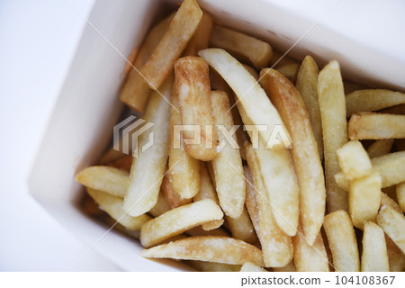 French fries in a cardboard box. Fast food. Fried potatoes. A delicious snack. 104108367