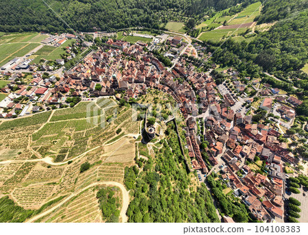 Aerial Drone Shot of the village of Kaysersberg in Alsace in a day. Summer in France, Castle and a beautiful City Aerial Drone Shot of the village of Kaysersberg in Alsace in a day. Summer in France, Castle and a beautiful City 104108383