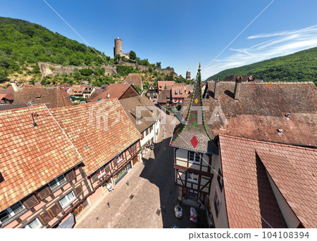 Aerial Drone Shot of the Streets in village of Kaysersberg in Alsace in a day. Summer in France, Castle above 104108394