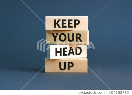 Keep your head up symbol. Concept words Keep your head up on wooden cubes. Beautiful grey table grey background. Business motivational keep your head up concept. Copy space. 104108783