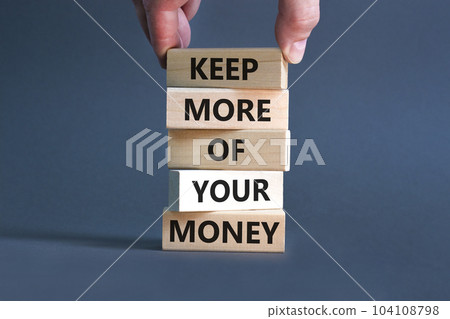 Keep more of your money symbol. Concept words Keep more of your money on wooden block. Beautiful grey table grey background. Businessman hand. Business keep more of your money concept. Copy space. Keep more of your money symbol. Concept words Keep more of your money on wooden block. Beautiful grey table grey background. Businessman hand. Business keep more of your money concept. Copy space. 104108798