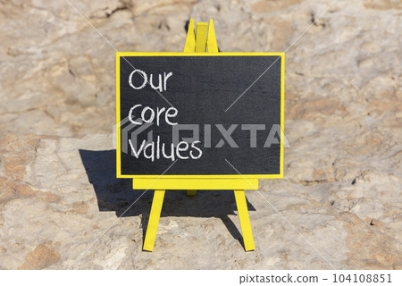 Our core values symbol. Concept words Our core values on black chalk blackboard on a beautiful stone background. Business and our core values concept. Copy space. 104108851