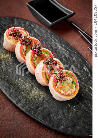 Tuna sushi rolls in mamenori with omelette, lettuce, avocado, orange, caviar Tuna sushi rolls in mamenori with omelette, lettuce, avocado, orange, caviar 104109357