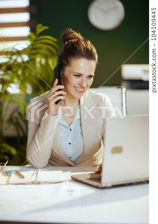 happy accountant woman in green office talking on phone happy accountant woman in green office talking on phone 104109445