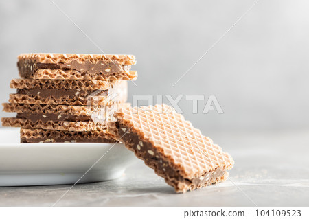 Sweet chocolate wafer on kitchen table. Sweet chocolate wafer on kitchen table. 104109523