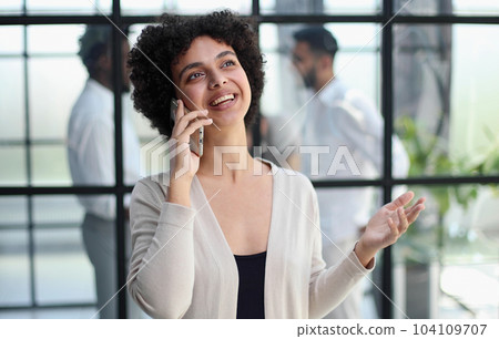Businesswoman with phone in modern office 104109707
