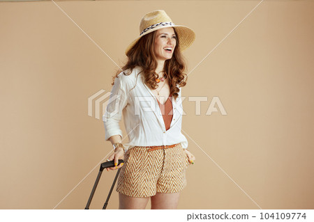 happy elegant woman in blouse and shorts on beige happy elegant woman in blouse and shorts on beige 104109774