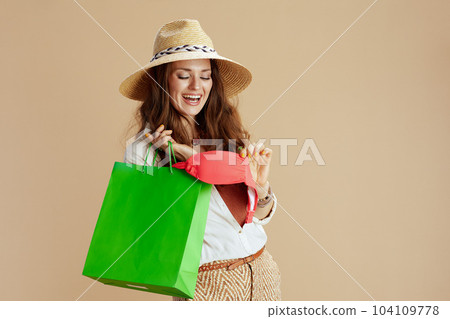 smiling elegant woman in blouse and shorts on beige smiling elegant woman in blouse and shorts on beige 104109778