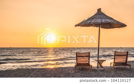Sunshade beach umbrellas with sunset sky and sea background. Sarande, Albania Sunshade beach umbrellas with sunset sky and sea background. Sarande, Albania 104110127