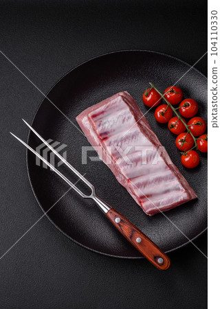 Raw pork ribs with meat with salt, spices and herbs Raw pork ribs with meat with salt, spices and herbs 104110330