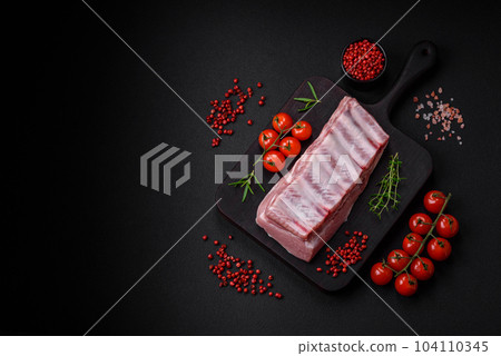 Raw pork ribs with meat with salt, spices and herbs Raw pork ribs with meat with salt, spices and herbs 104110345