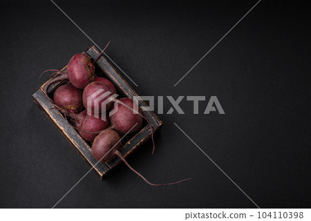 Fresh raw beetroot in the form of tubers on a textured concrete background Fresh raw beetroot in the form of tubers on a textured concrete background 104110398
