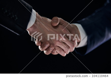 Close-up image of handshake between two colleagues. Close-up image of handshake between two colleagues. 104110464