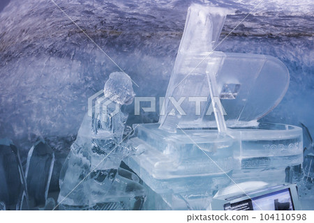 Beautiful ice statue of man playing piano in glacier tunnel at ice palace in Jungfrau, Switzerland, winter holiday travel concept 104110598