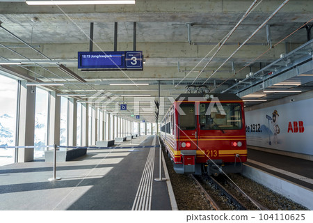 Red electric train parked at empty Jungfrau railway station in Switzerland, winter holiday concept for tourists Red electric train parked at empty Jungfrau railway station in Switzerland, winter holiday concept for tourists 104110625