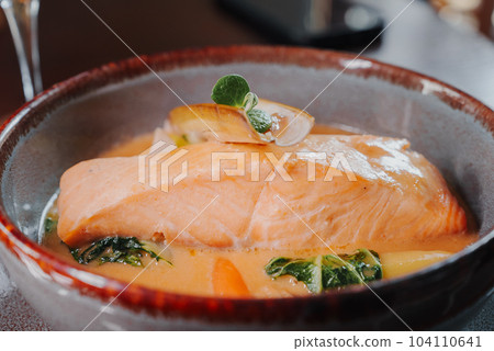 Fried salmon steak with potatoes and vegetables and spicy sauce. Vegeterian dish. Fried salmon steak with potatoes and vegetables and spicy sauce. Vegeterian dish. 104110641