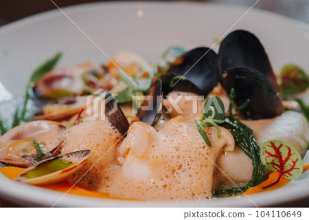 Close up view of the grilled scallop on a plate with mussels. Close up view of the grilled scallop on a plate with mussels. 104110649