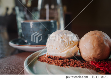 Yummy delicious colorful ice cream on a plate next to the coffee. Yummy delicious colorful ice cream on a plate next to the coffee. 104110659