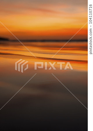 Idyllic view of beautiful seascape and sandy beach with reflection of sunlight under cloudy sky during sunset at Costa Rica, nature and travel concept. Idyllic view of beautiful seascape and sandy beach with reflection of sunlight under cloudy sky during sunset at Costa Rica, nature and travel concept. 104110716