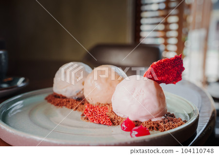 Yummy delicious colorful ice cream on a plate next to the coffee. 104110748