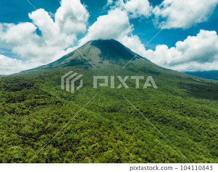 Amazing view of beautiful Arenal volcano in Costa Rica. Panorama of volcano Arenal reflected on wonderful picturesque lake, La Fortuna, Costa Rica. Central America. Amazing view of beautiful Arenal volcano in Costa Rica. Panorama of volcano Arenal reflected on wonderful picturesque lake, La Fortuna, Costa Rica. Central America. 104110843