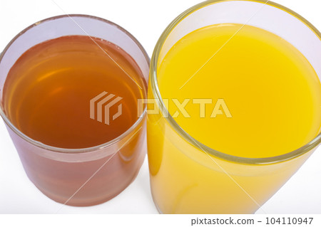 Two glasses of fresh orange and apple juice isolate 104110947