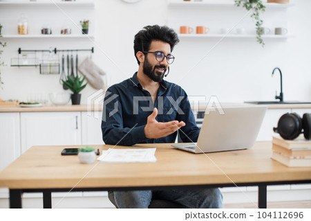 Remote employee holding online briefing via laptop at home 104112696