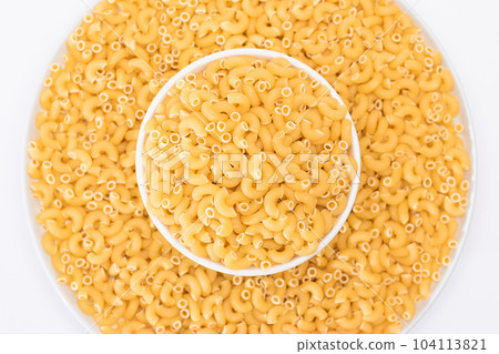 Uncooked Chifferi Rigati Pasta in White Plate on White Background Uncooked Chifferi Rigati Pasta in White Plate on White Background 104113821