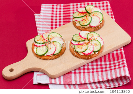 Cracker Sandwich with Cream Cheese, Fresh Cucumber and Radish 104113860