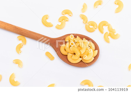 Uncooked Chifferi Rigati Pasta in Wooden Spoon on White Background Uncooked Chifferi Rigati Pasta in Wooden Spoon on White Background 104113919