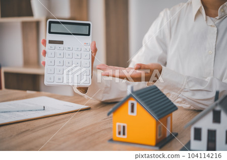 Salesperson Holding house keys concept, house keys for new house, new house purchase. Salesperson Holding house keys concept, house keys for new house, new house purchase. 104114216