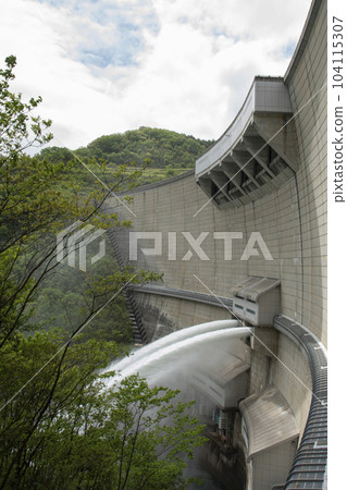 Water discharge from Nukui Dam and blue sky seen from below 104115307