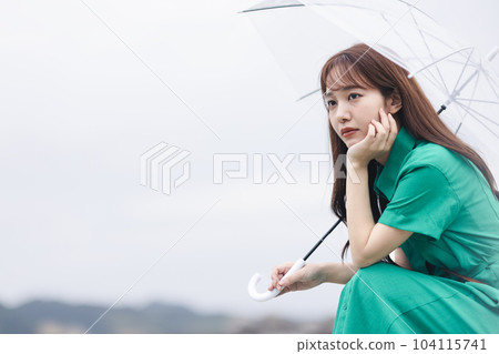 A woman holding an umbrella 104115741